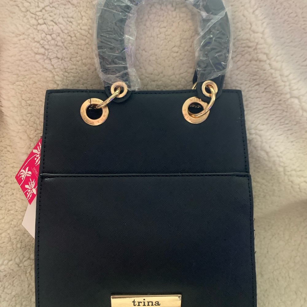 Trina Turk Textured Black Vegan Leather Handbag with Gold Detail.